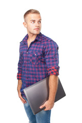 Portrait of smiling young man holding laptop