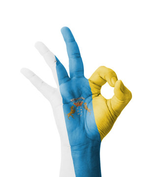 Hand making Ok sign, Canary Islands flag painted