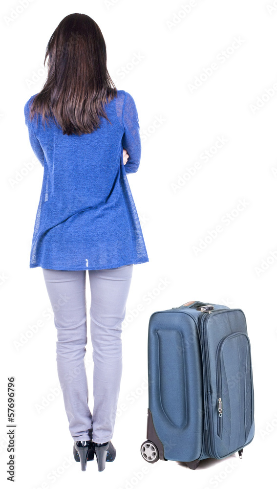 Wall mural back view of standing young beautiful brunette woman.