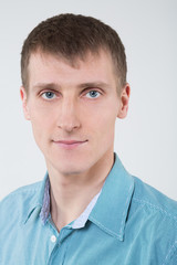 Closeup portrait of a man in a shirt with blue eyes