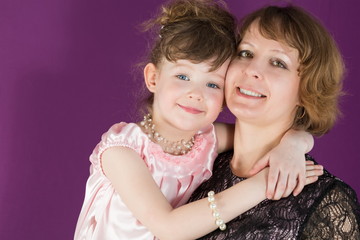 Portrait of a mother and young daughter in room