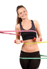 Fototapeta na wymiar Fit girl with measuring tapes around her body with dumbbells