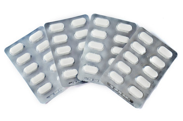 white medical pills in blister pack isolated on white background