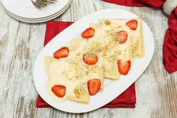 Crepes with honey, strawberries and walnuts