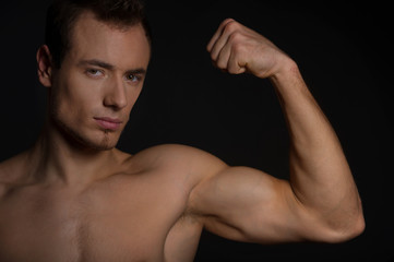 Fototapeta na wymiar Handsome man showing his muscles.