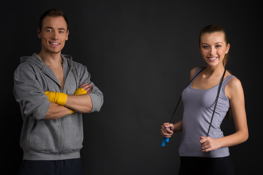 Two couches smiling at camera.