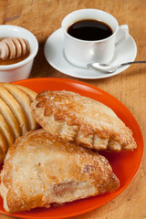 Breakfast including coffee, bread, honey.