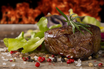 Grilled steaks on wood