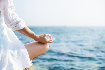 Woman meditating at the sea