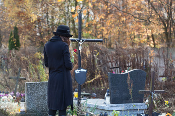 Woman in mourning at cemetery