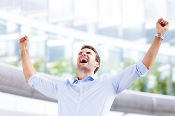 Business man with arms raised
