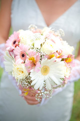 White and pink flowers in hands of married woman