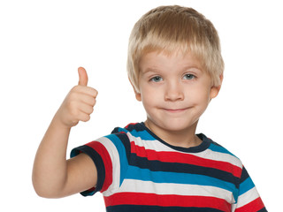 Smiling little boy holds his thumb up