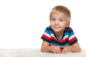 Smiling cute boy on the white carpet