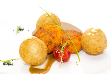 carrot vegetarian meatballs on a white plate in a restaurant