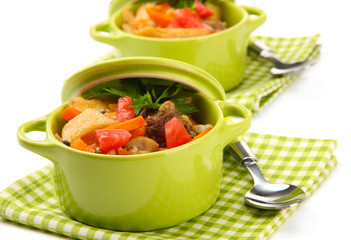 Homemade beef stir fry with vegetables in color pans, isolated