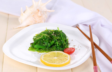Sea kale on plate on wooden table close-up