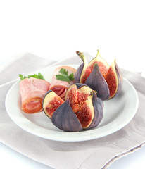 Tasty figs with ham, isolated on white