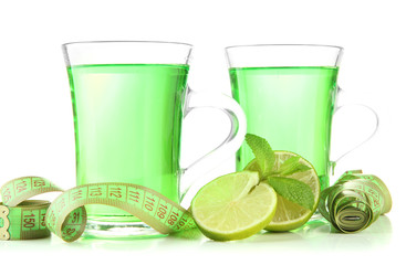 Two transparent cups of green tea and measuring tape isolated