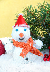 Beautiful snowman and Christmas decor, on golden background