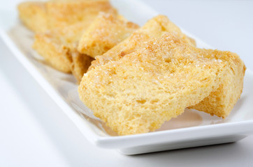 mini toasts with sugar close up on a white background