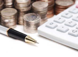 Old dusty ball pen on calculator with stack coins background