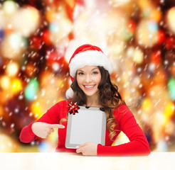 woman in santa helper hat with tablet pc