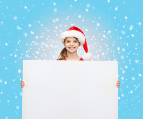 woman in santa helper hat with blank white board