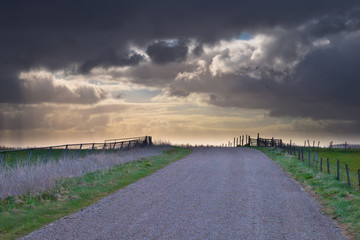 Rural road is leading to spectacular cloudscape