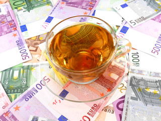 tea or coffee cup on money wallpaper