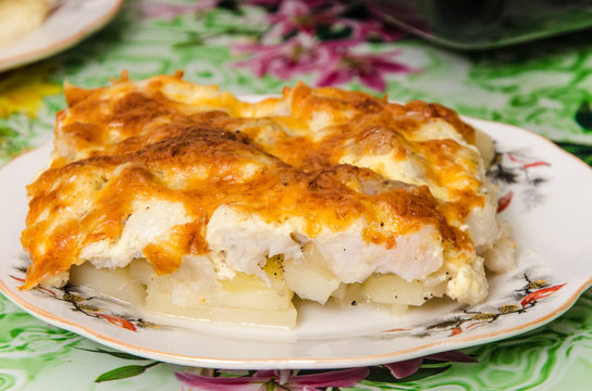 Fish and potatoes baked with cheese