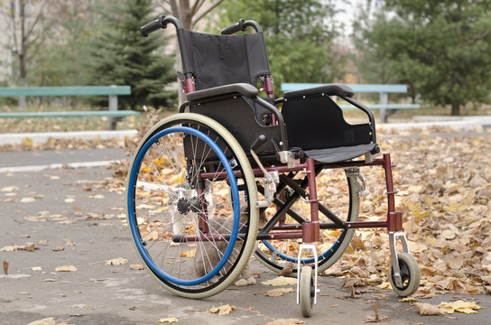 One wheelchair outdoors in the park