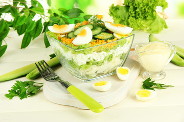 Delicious salad with eggs, cabbage and cucumbers on wooden