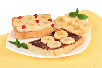 Delicious toast with bananas on plate close-up