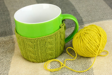 Cup with knitted thing on it close up