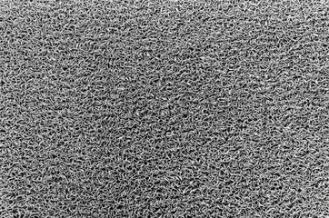 Texture background of the gray plastic door mat