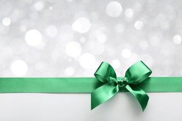 Green ribbon bow with bokeh