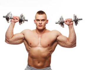 Fototapeta na wymiar Handsome young muscular man exercising with dumbbells