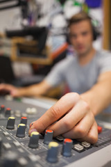 Handsome radio host moderating turning up volume