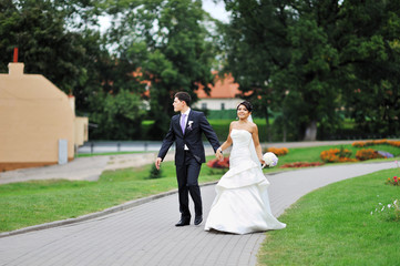 Bride and groom walking in an old town