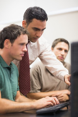 Teacher and mature student in computer room