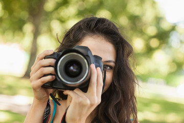 Pretty brunette woman taking a picture