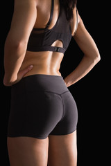 Mid section of the backside of young slim woman wearing sportswe