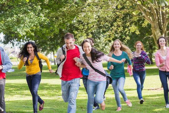 College Students Running In The Park