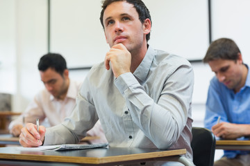 Mature students taking notes in classroom