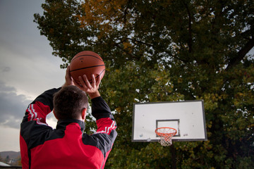 Basketball player silhouette at sunset