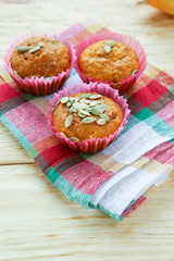 Three pumpkin muffins with seeds