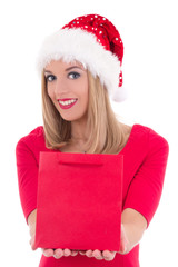 portrait of young woman in santa hat with gift bag isolated on w