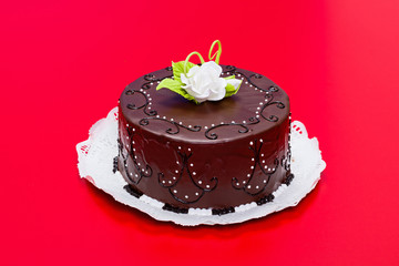 Chocolate cake with white candy rose decoration