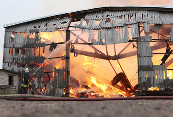 Burning farm building with hay
